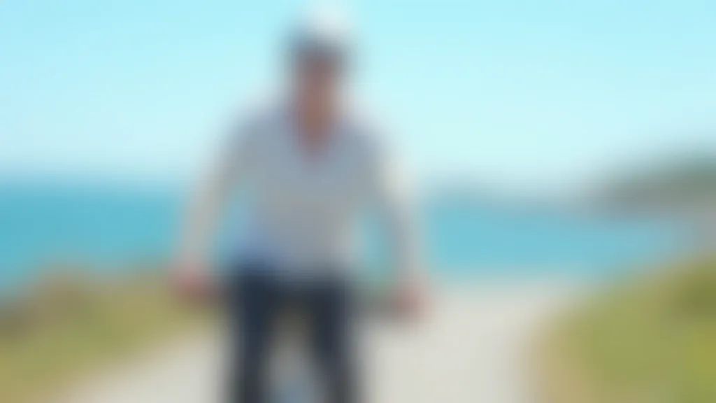 Senior woman cycling on flat coastal path with water in background, clear weather, confident posture